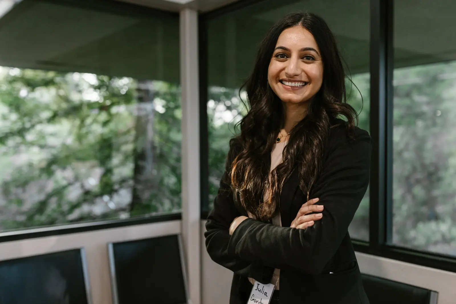 A young founder smiling with her arms crossed.